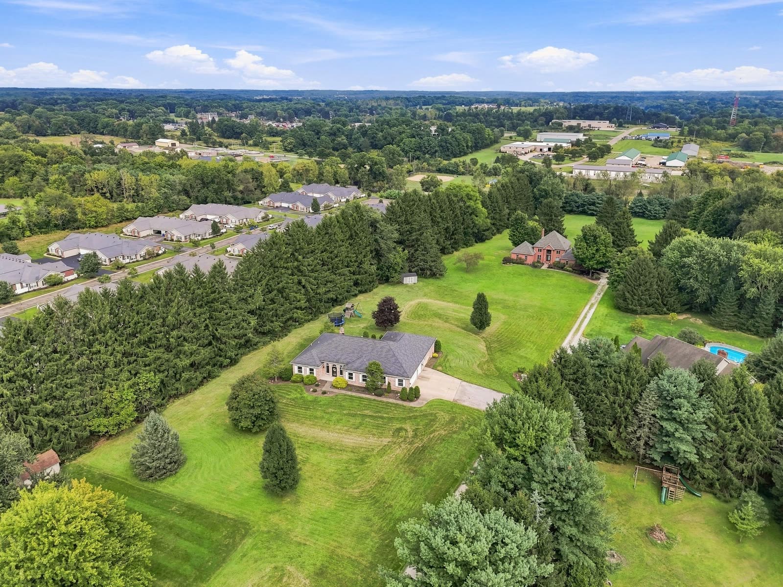 Drone aerial over a listing on a wooded lot